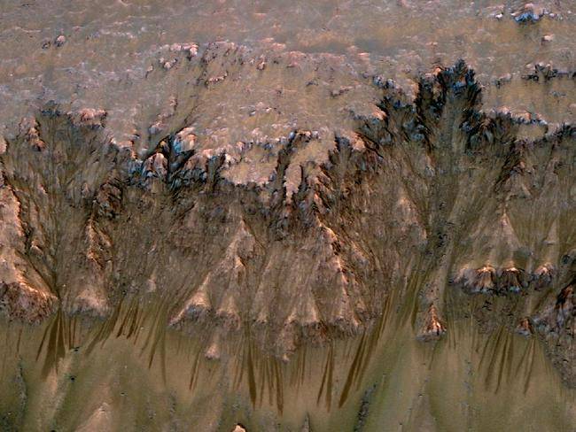 NASA spacecraft orbiting Mars have returned clues for understanding seasonal features that are the strongest indication of possible liquid water that may exist today on the Red Planet.