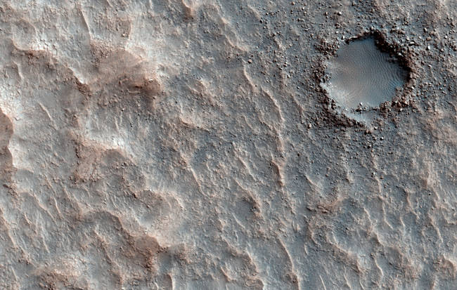 A small impact crater, surrounded by ejecta, is filled in with rippled sand on the floor of Ritchey Crater. More, or see location on Google Mars.