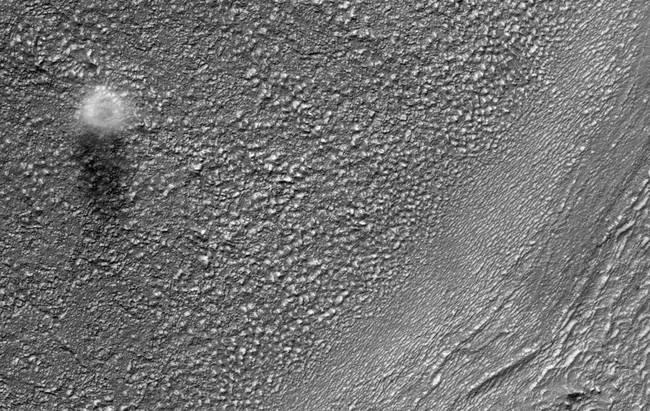 HiRISE catches a dust devil blowing across the Martian surface east of the Hellas impact basin and south of Reull Vallis. The diameter of this dust devil is about 200 meters, but at the surface it is probably much smaller. Based on the length of the shadow in this image, the dust devil is on the order of 500 meters tall.
