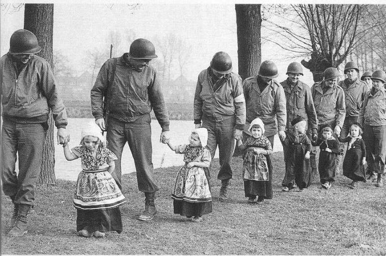 American soldiers take Dutch children to a dance. World War II, c. 1944 - 1945