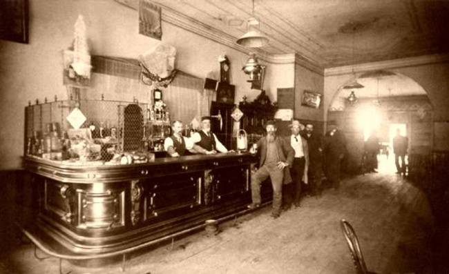 Two Barmen Tend to An Old West Saloon