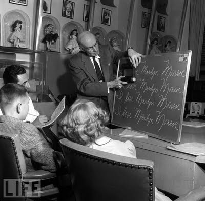 15 Handwriting Game, 1955 A handwriting game being analysed by members of the Ideal Toy panel on Inventor's Day at the Ideal Toy Company in Hollis, New York. Because there's nothing children love more than handwriting.