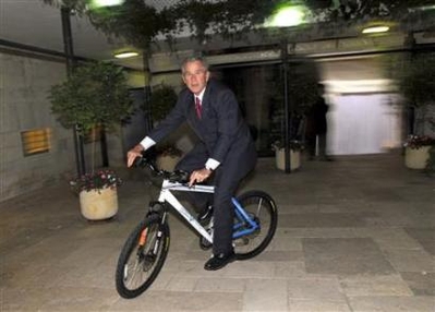 President Bush rides a special edition of an Israeli made bicycle he received from Israel's Prime Minister Ehud Olmert 