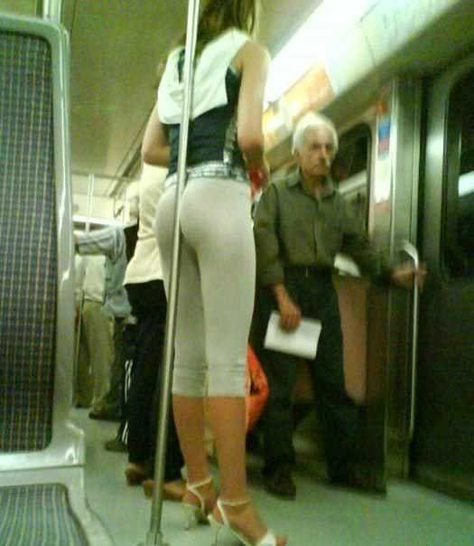 Tightly hugging the subway rail. Wonder what else she can grab