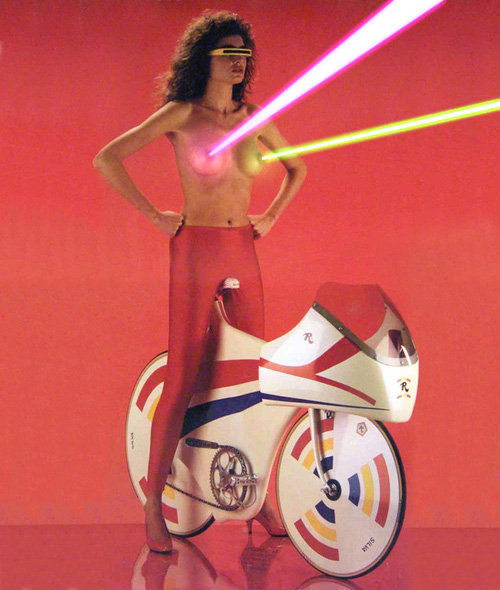 Laser nipples woman on a super bike.