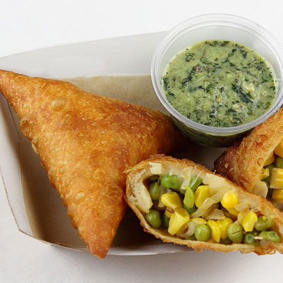 Butter Chicken Samosas.  Pastries filled with chicken in a tomato curry sauce and served with a side of green chutney. Sweet Summer Vegetable Samosas with corn, peas and onions also are available.