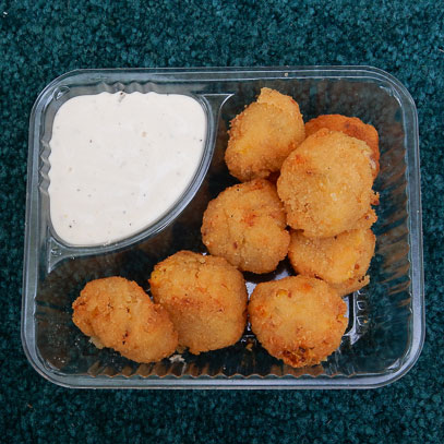 Cowboy Bites.  Sweet corn kernels, bacon, jalapeños and cream cheese blended into bite-size balls, breaded and fried, and served with ranch dipping sauce