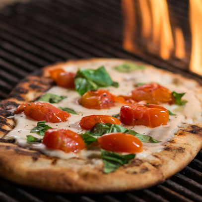 Grilled Venetian-Style Pizza.  Grilled over an open flame for a crispy crust and offered in three varieties: Margherita (oven-roasted tomatoes, cheese and basil); Farm Fresh (olives, sweet red peppers, arugula greens and fresh goat cheese); and Spicy Salami (thin-sliced salami, cheese, oregano and red pepper flakes)
