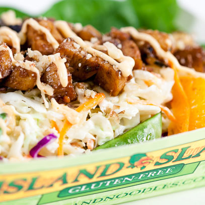 Island Slaw.  Gluten-free island-style coleslaw with pineapple, mandarin oranges, sugar snap peas and spinach, all topped with teriyaki chicken, a light Sriracha glaze and macadamia nuts