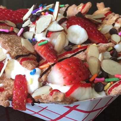 Italian Dessert Nachos.  Cinnamon sugar cannoli chips smothered with sweet ricotta cheese filling, fruit, chocolate, nuts and candy toppings