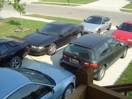 Too many cars in front yard Ass Clown
