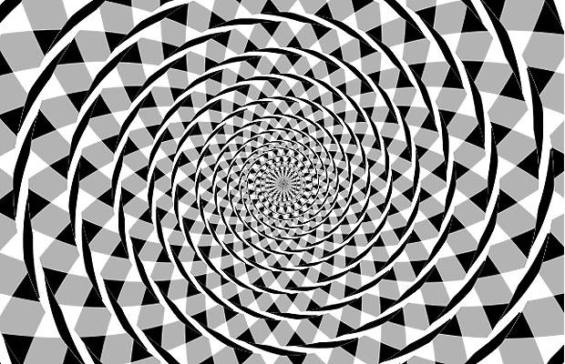 The overlapping black arcs appear to form a spiral; but, the arcs are simply a series of concentric circles. 
