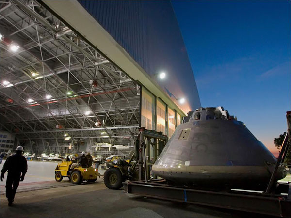 The Orion capsule used in the Constellation program looks like the capsules from the Apollo program, but it is a much bigger beast. The Apollo capsules that went to the moon carried three astronauts; Orion can hold as many as six. In this photograph, a mock-up of the Orion capsule is moved into a hangar at NASA's Langley Research Center in Hampton, Virginia.