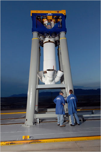 The Ares I will have an escape tower that will pull the Orion capsule away from the rocket in case of emergencies that require an abort during launching. Technicians at Alliant Techsystems inspect an inert escape rocket abort motor on its test stand in Promontory, Utah .