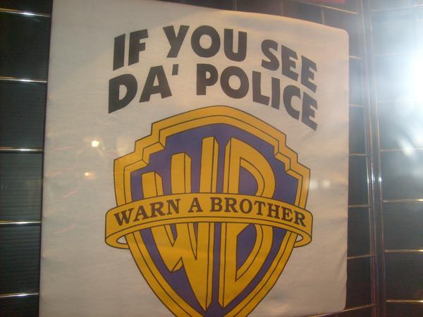A picture of a poster, a funny version of the Warner Brothers logo