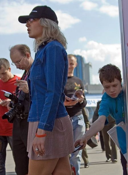 Kid sneaks picture under ladies skirt