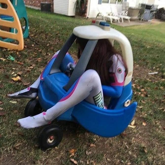 Woman riding in a kids toy car