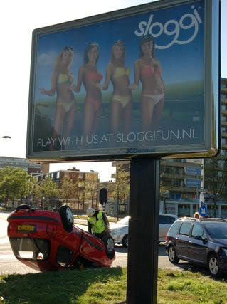 Beautiful models on a billboard will always be a distraction to any male driver. This guy even ended up crashing his car! 