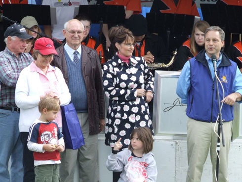 One of Sarah Palin's little girls gives the one finger salute to a boy in front of her.