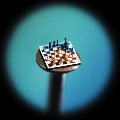 the chess set is on top of a pinhead.