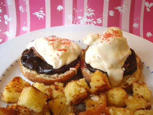 Cadbury Creme Eggs Benedict...Sliced doughnuts topped with brownie mix, melted Cadbury Creme Eggs and frosting, garnished with red sprinkles and served with fried pound cake chunks