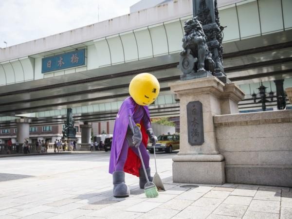 Anonymous Man In A Superhero Costume Is Fighting Grime In Tokyo