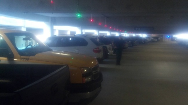 Parking garages with lights showing open spaces.