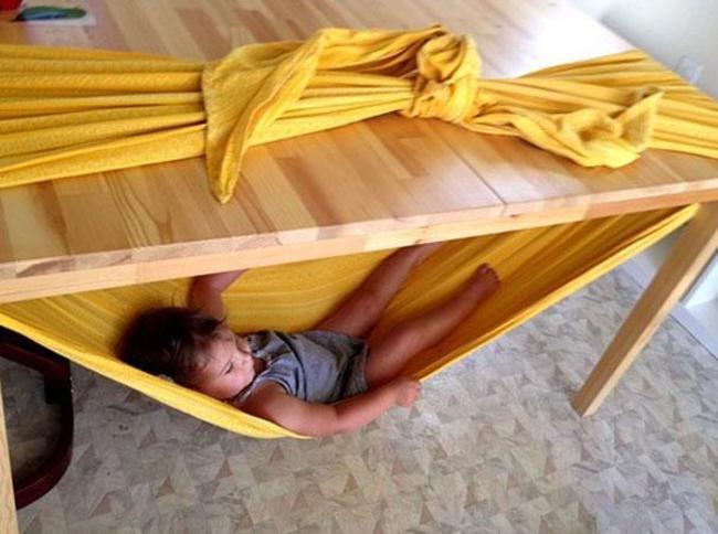 Create a tiny hammock for your child using only a blanket and a table.