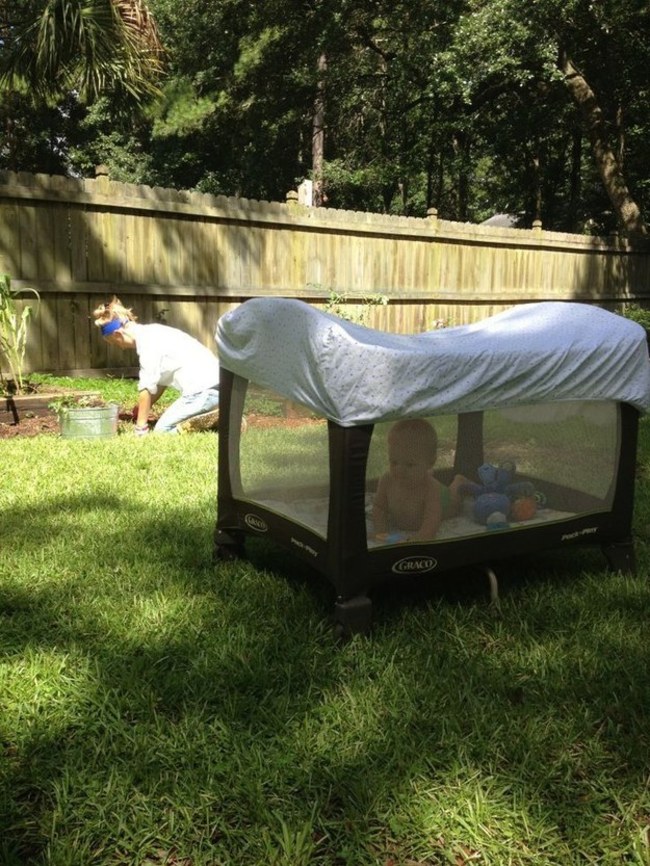 Cover a pack and play with a fitted sheet so your child can stay cool outside and won't be bitten by bugs.