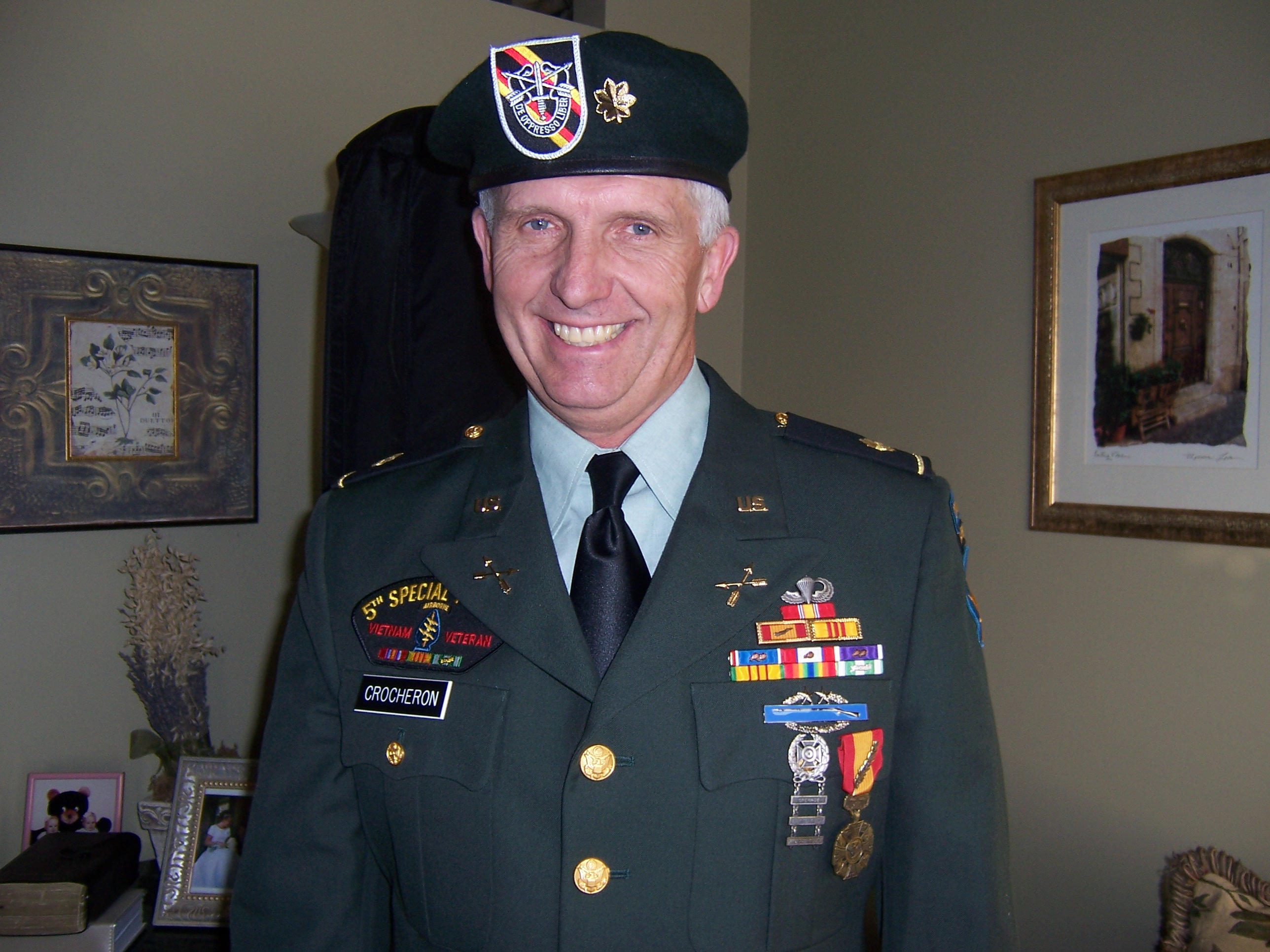1. The flash on his Green Beret isn't the authorized flash, it's a store bought replica. 2. The Green Beret crest, pinned upon the flash upon his beret doesn't belong there for an officer. His Major's oak leaf's are supposed to be mounted on the flash. 3.3. His shoulder epaulets are incorrect for a Green Beret officer. 4. His ribbons are not placed correctly they should be aligned to the left, not in a pyramid configuration. 5. His C.I.B. Combat Infantrymen's Badge - the rifle with the wreath should be placed above his jump wings.And these are only a few of the problems with this man's uniform..
