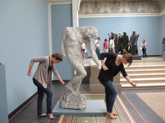 People Having Fun Posing With Statues