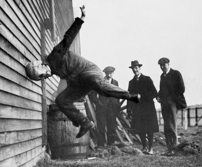 A man testing a prototype football helmet. [1912]