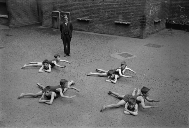 Children without access to water learn to swim in a schoolyard. [c. 1920s]