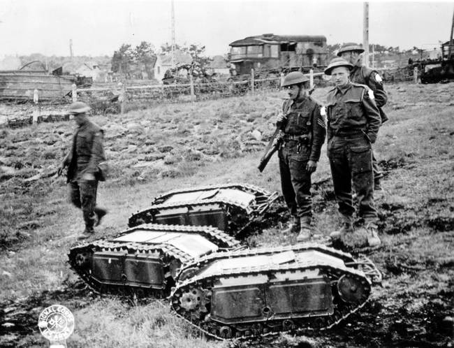 British Soldiers with captured German Goliath tank busters, which would drive under tanks and explode. [c. 1939-1945]