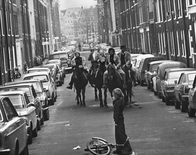 Four horsemen ride through the streets of Amsterdam on a ‘motor-less day’, when cars were prohibited due to the oil crisis. [1973]