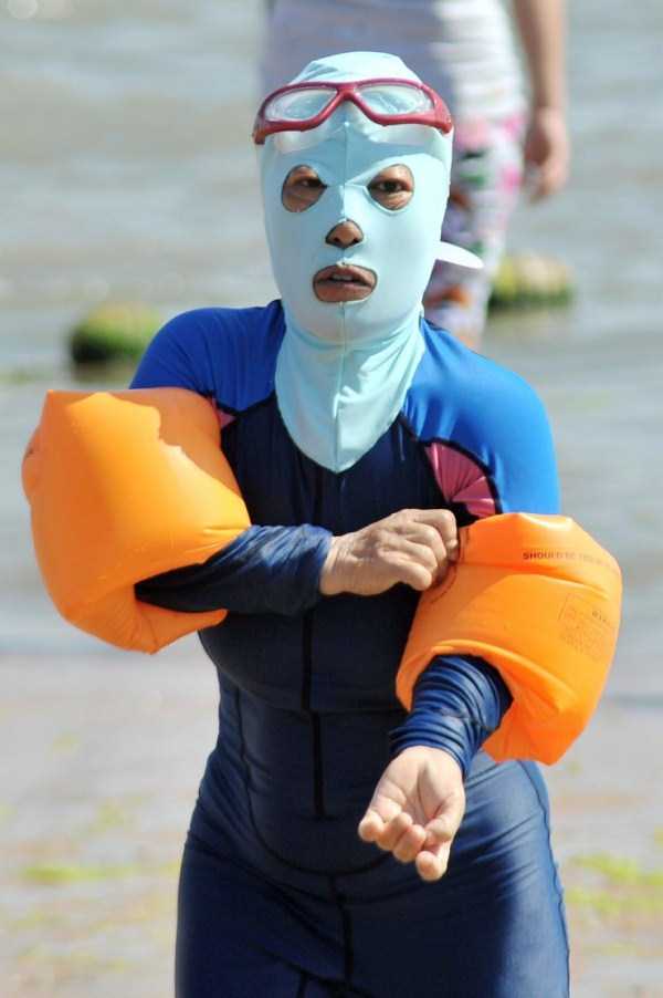 The mask is being worn to protect from the sun's ultraviolet rays as well as defense from jellyfish stings and algae. The face-kini covers the entire face except for the eyes, nose and mouth, and is often worn with a long-sleeved shirt or a full body wet suit for complete protection.
