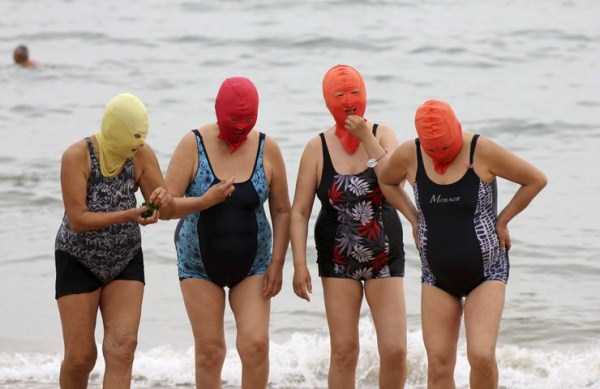 It is thought that the bright orange versions of the masks can help scare away sharks.