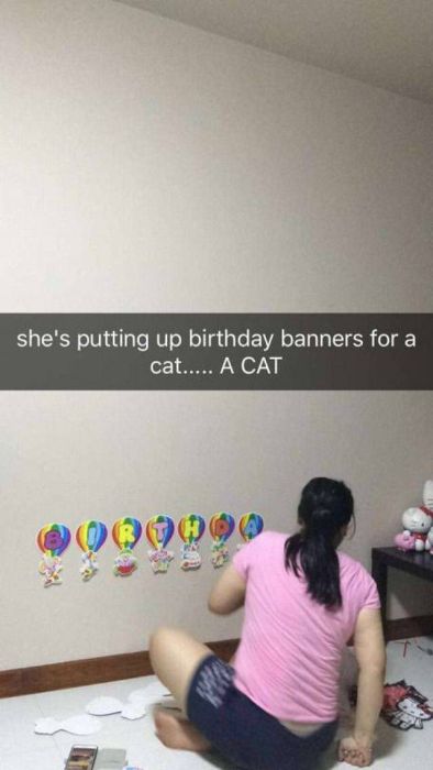 shoulder - she's putting up birthday banners for a cat..... A Cat 0000