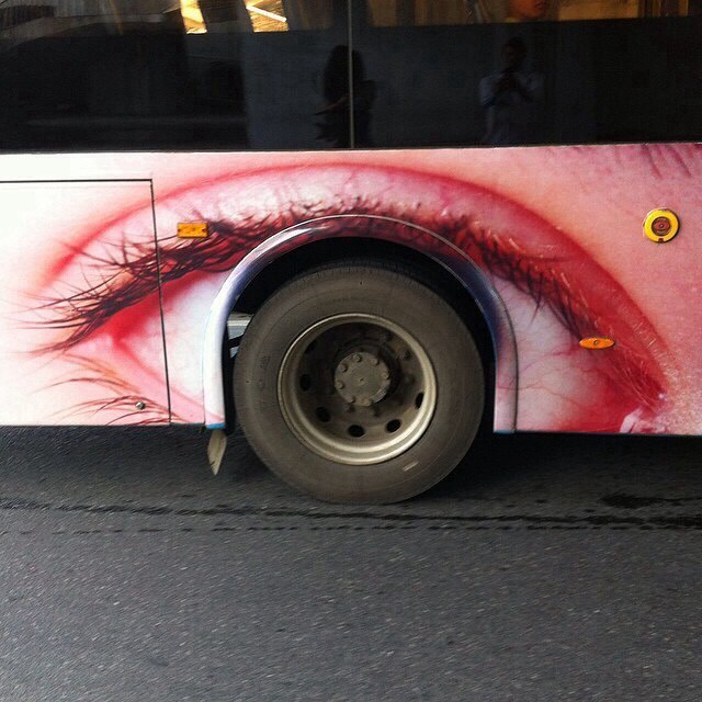 Bus wheel that looks like an eye.
