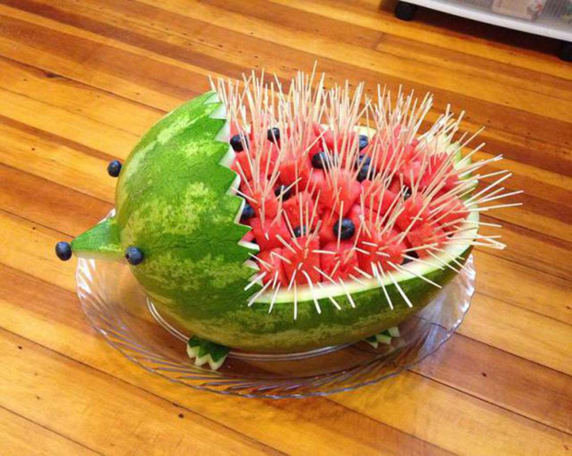 Awesome fruit art of a watermelon carved into a porcupine with toothpicks for quills and olive's for eyes and nose. Feet were carved out of extras from the watermelon peel.