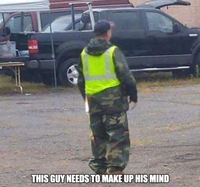 man dressed in camouflage and a safety vest, really needs to make up his mind about if he wants to be seen or not.