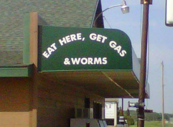 sign that invites you to eat here, get gas and worms. Tempting offer.