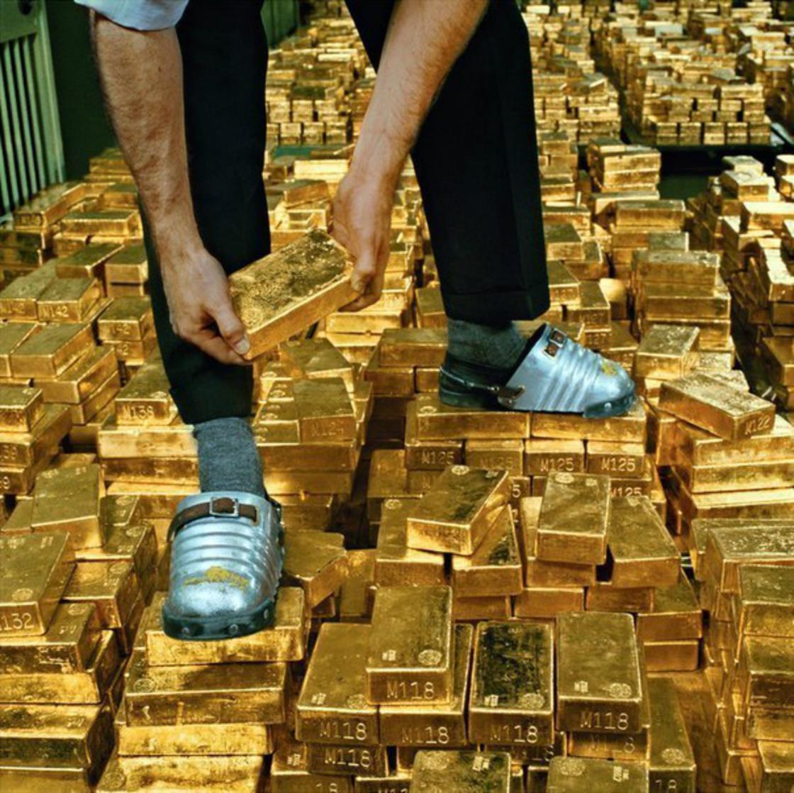 Man walking on piles of gold