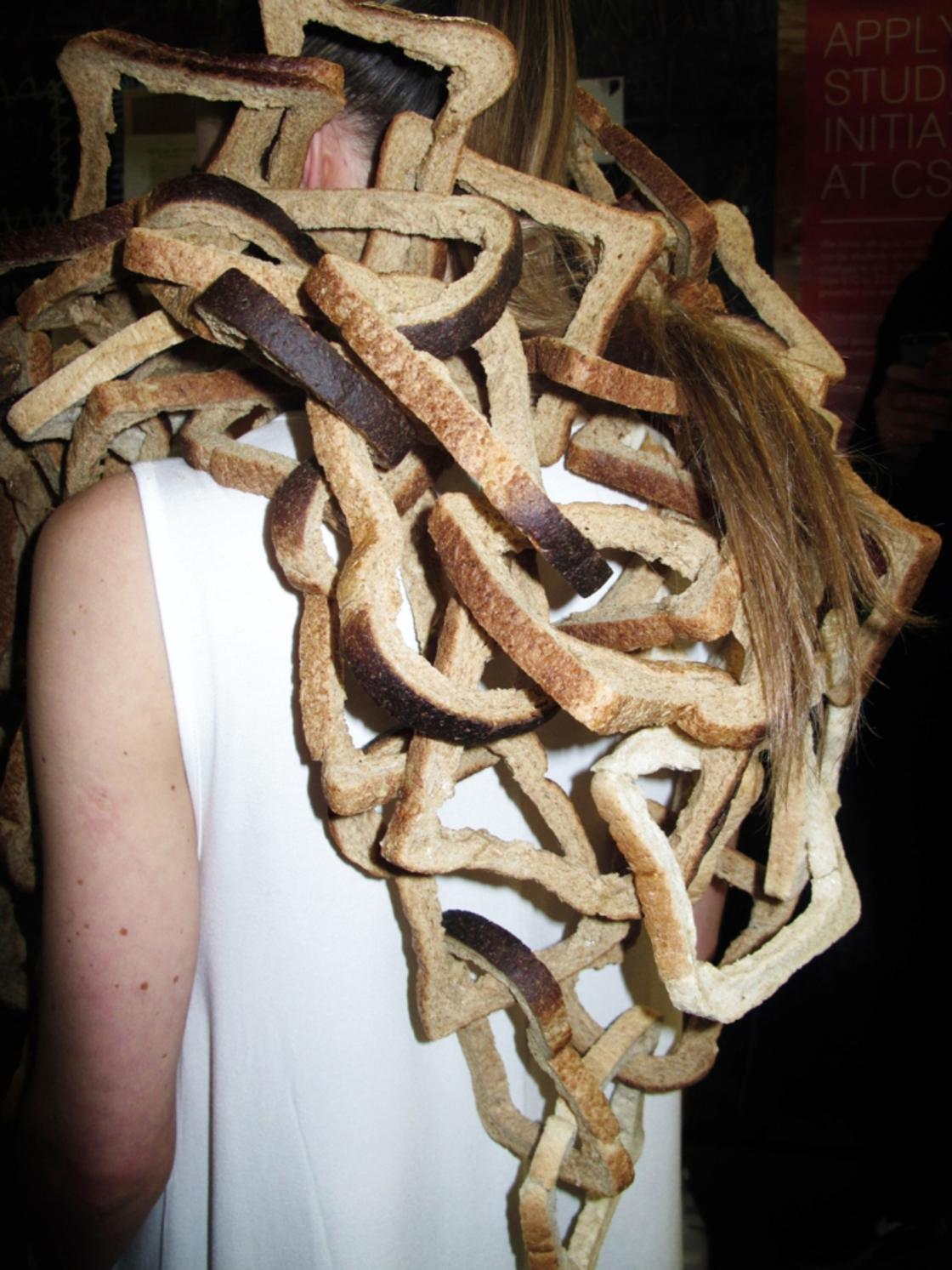 Girl wearing bread crusts in her hair.
