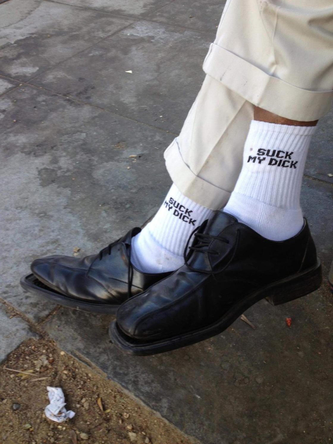 Man with crass comment on his socks, because you know girls are checking that out.