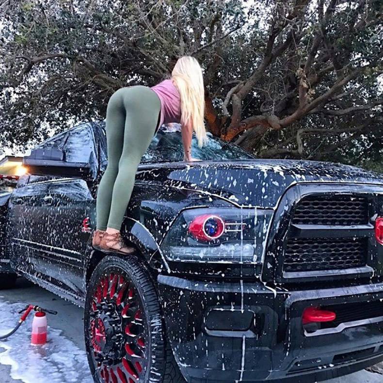 Hot girl washing massive pickup truck