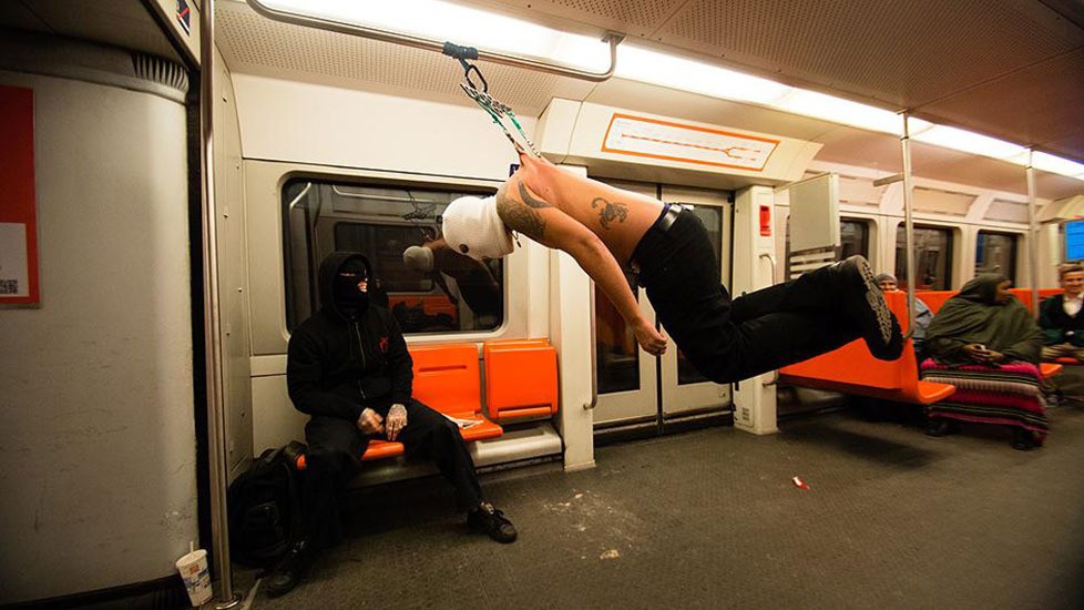 Man hanging his skin from hooks on the subway