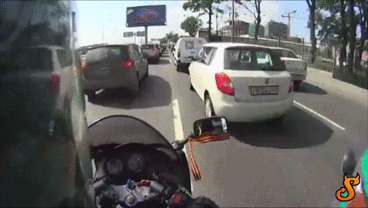GIF of motorcycle cutting through traffic till someone opens their door.