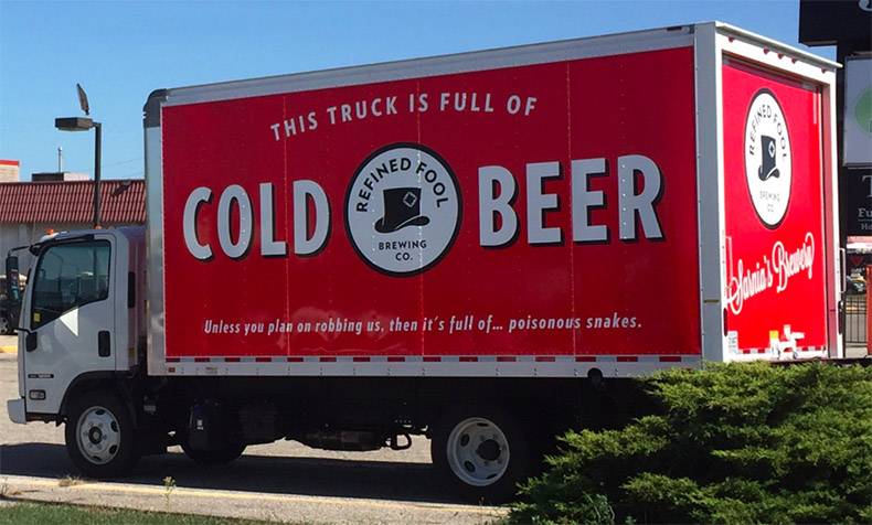 Funny truck mural that explains it is cold beer, unless you are considering robbing the truck, in which case it is full of snakes.