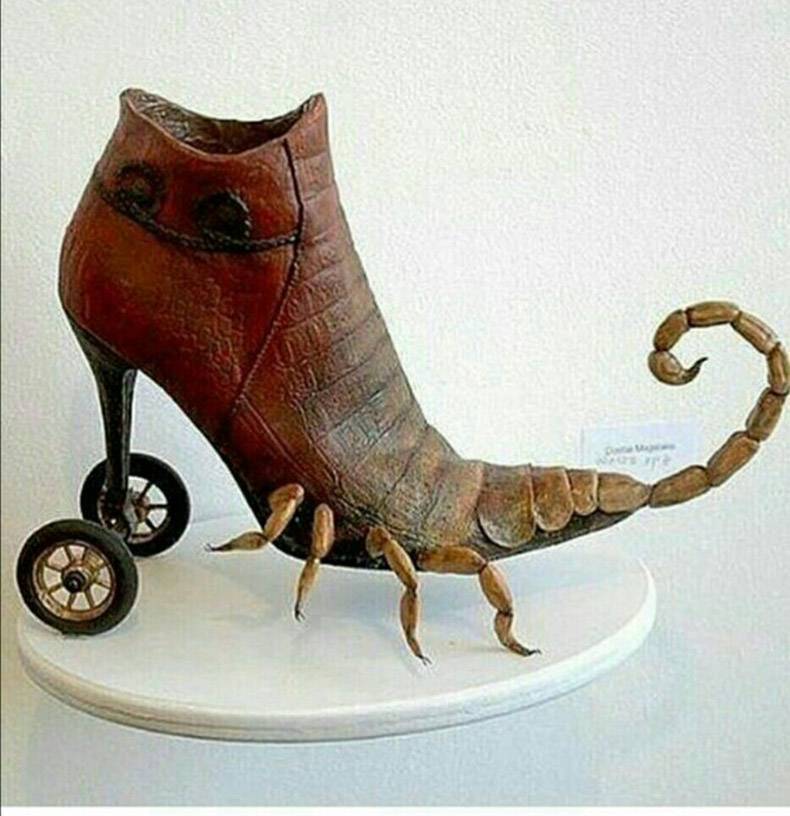 High heel shoes with sheels on heel, and scorpion tail backwards on the front